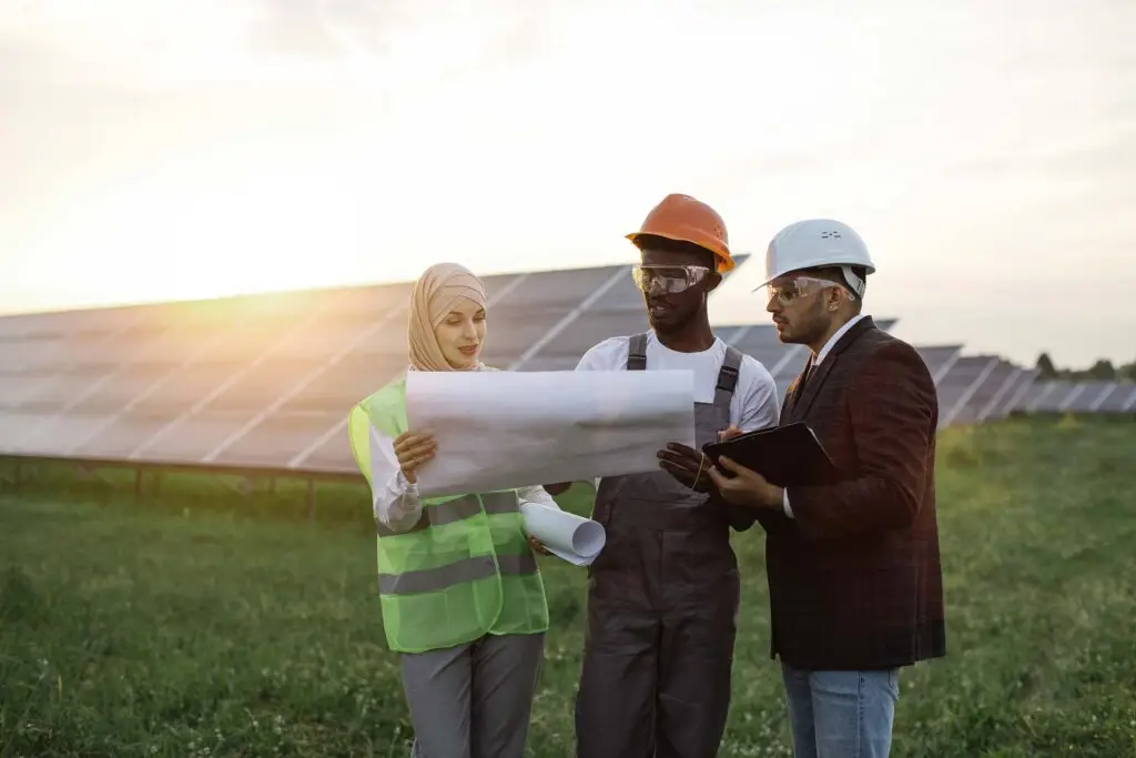 multi ethnic people discussing work at solar stati HFXPKUV